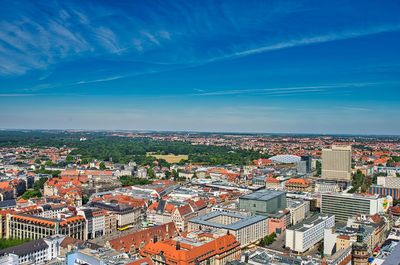 High angle view of city against blue sky