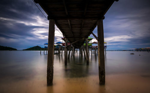 Pier on river against sky