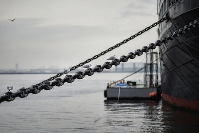 Close-up of ship on sea against sky