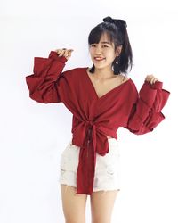 Portrait of a smiling young woman against white background