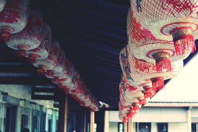 Low angle view of multi colored decorations hanging against building