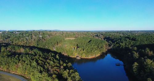 Scenic view of green landscape against clear blue sky