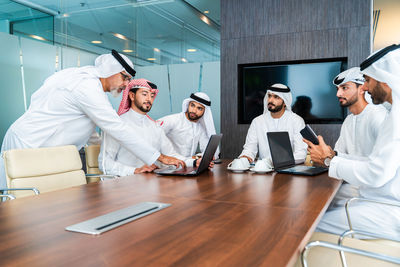 Portrait of male friends working in office