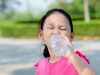 Portrait of a girl drinking water