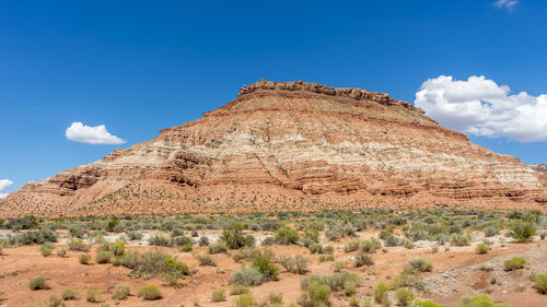 Low angle view of rock formations against blue sky