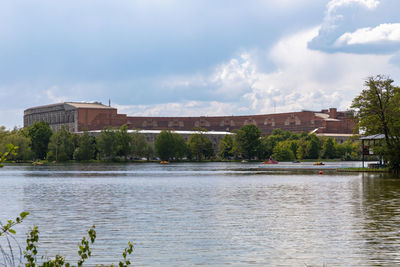 River by buildings against sky