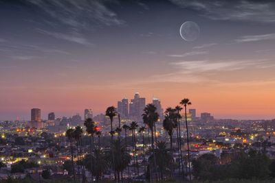 High angle view of buildings in city against sky during sunset