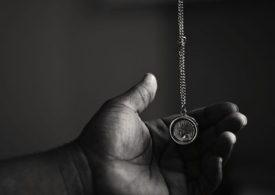 Cropped image of person with pendant