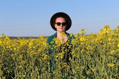 Portrait of women with yellow flowers in field