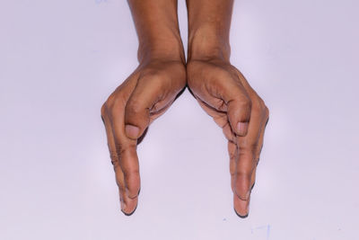 Low section of person against white background