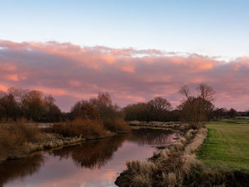 Scenic view of lake against sky during sunset