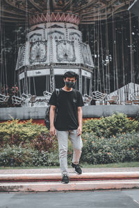 Full length portrait of young man standing outdoors