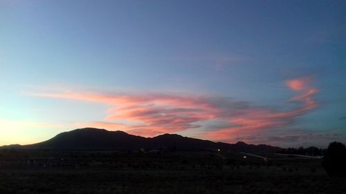 Silhouette landscape against sky during sunset