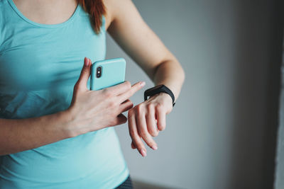 Midsection of woman using mobile phone