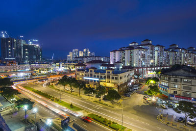 High angle view of illuminated city street and buildings at night