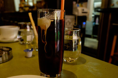 Close-up of wine glasses on table