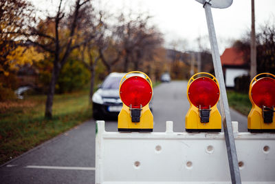 Close-up of red lights on road in city