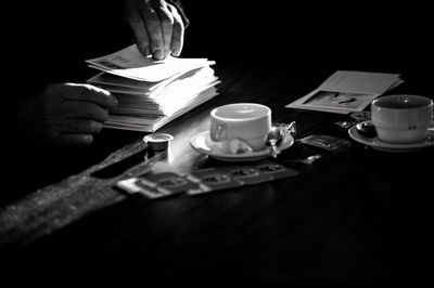 Close-up of hand holding tea cup on table