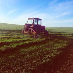Farmer in tractor plowing field