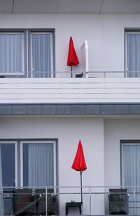 Low angle view of red flags against building