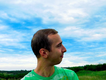 Boy on field against sky