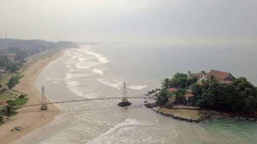 High angle view of temple by sea against sky