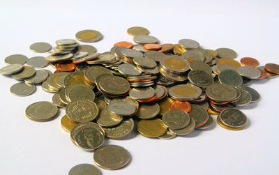 High angle view of coins on white background