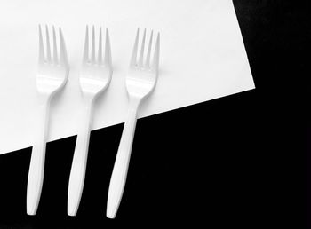 High angle view of fork on table against black background