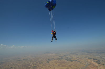 Man paragliding against clear sky