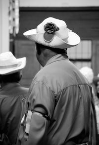 Close-up of man wearing hat and costume in city