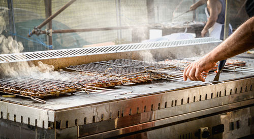 Man working on barbecue grill