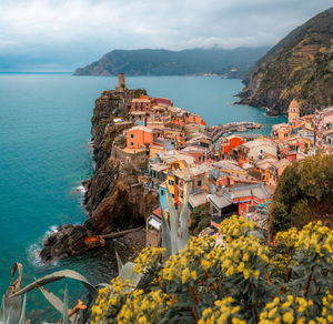 High angle view of townscape by sea against sky