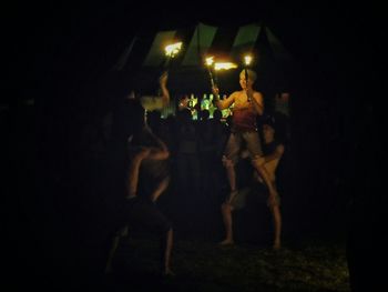 Blurred motion of illuminated people at night