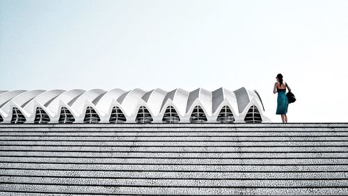 Full length of woman standing on steps