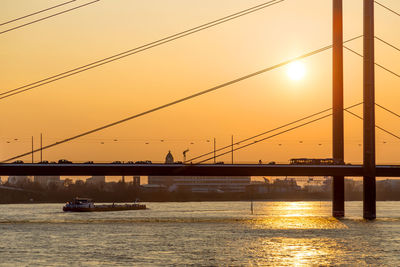 Bridge over river at sunset