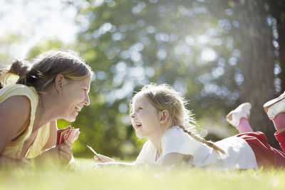 Smiling mother and daughter together