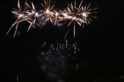 Low angle view of firework display at night