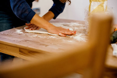 Midsection of man preparing food on table