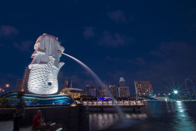 Statue of illuminated city buildings at night