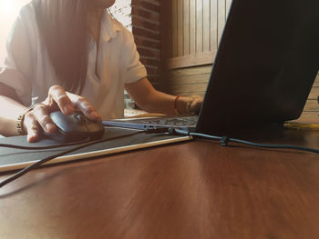 Midsection of woman working on table