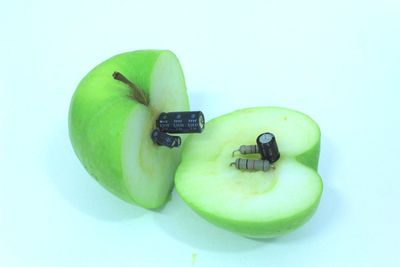 Close-up of green fruit against white background