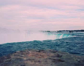 Scenic view of sea against cloudy sky