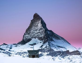 Scenic view of snowcapped mountains against clear sky