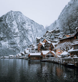 Houses on snowcapped mountain against sky