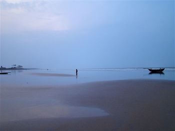 People on beach against sky