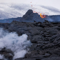 Scenic view of volcanic mountain against sky