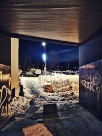 Illuminated street light on table at night during winter