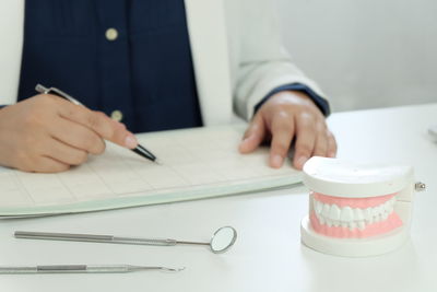 Midsection of man working at table