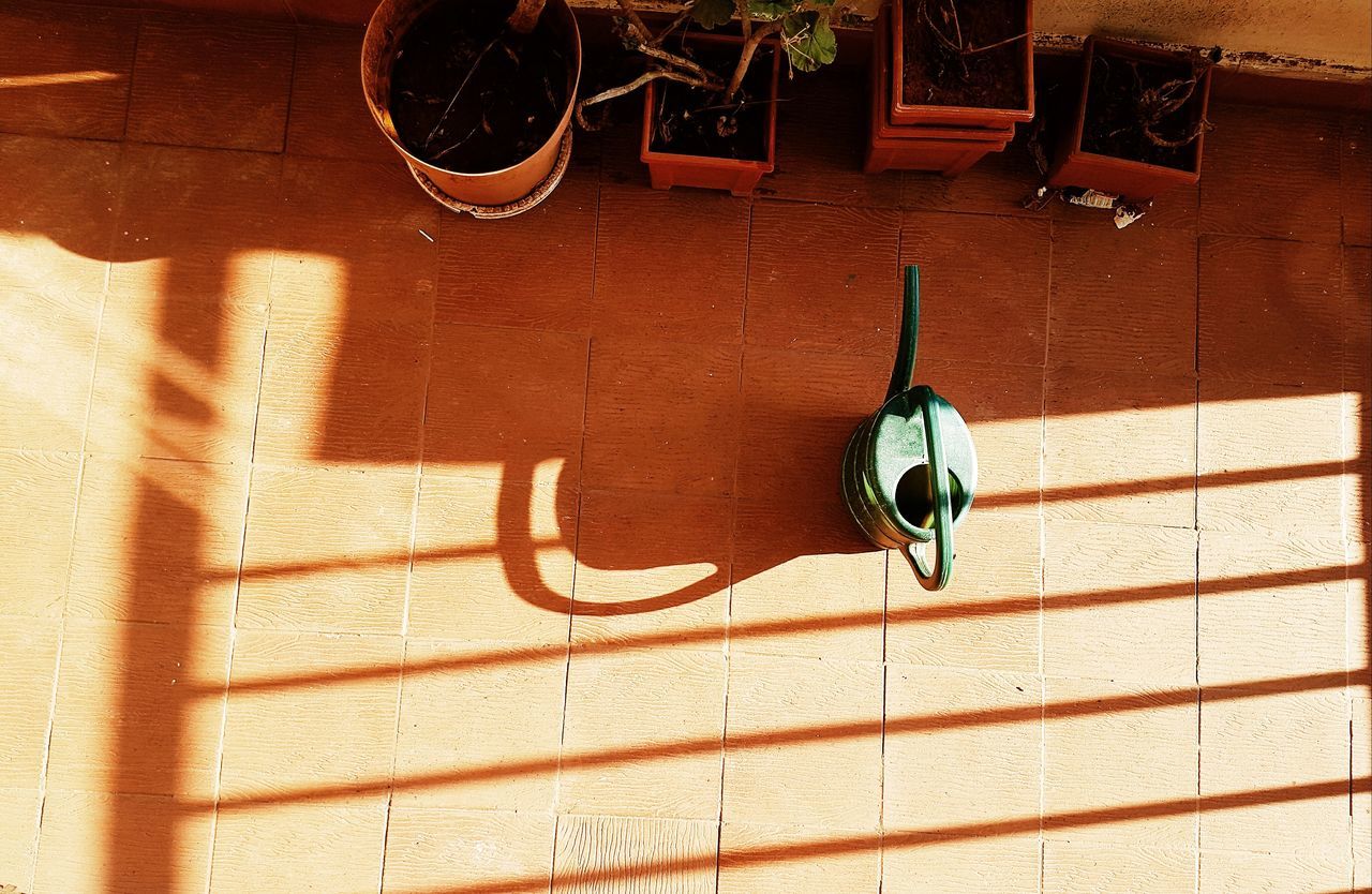 HIGH ANGLE VIEW OF MOTORCYCLE ON BRICK WALL