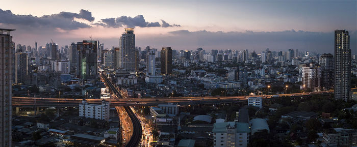 Aerial view of illuminated cityscape against sky